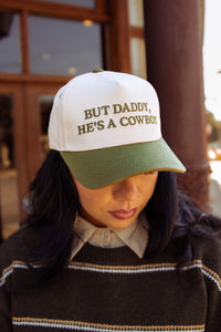 But He’s a Cowboy Trucker Hat in Green