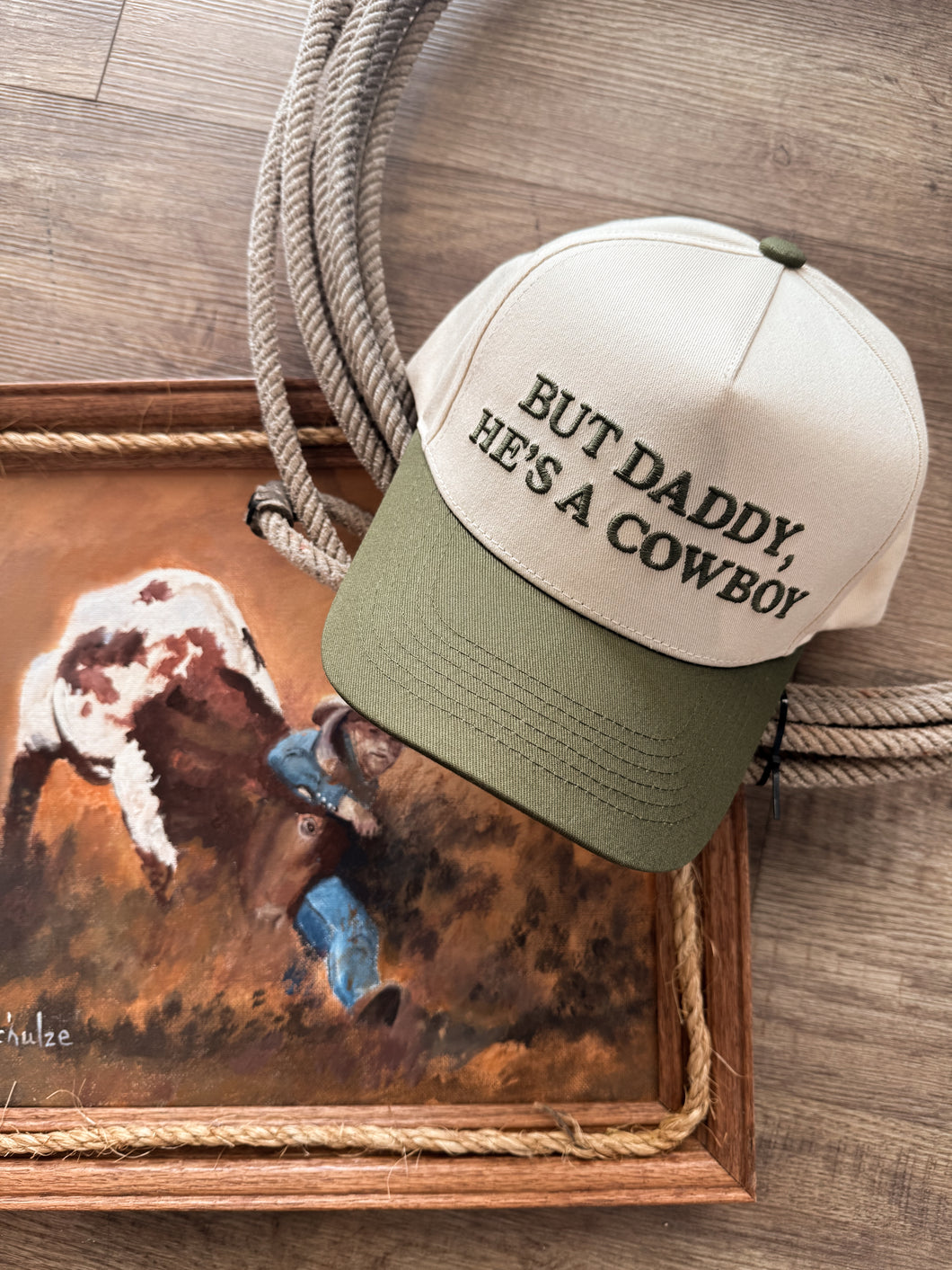 But He’s a Cowboy Trucker Hat in Green